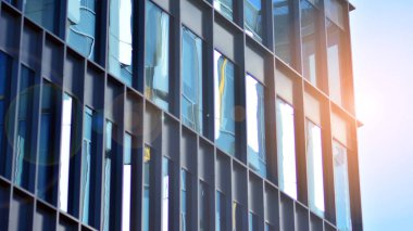 Şehir soyutu - ofis binasının pencereli duvarı. Şehirdeki modern iş binasının detaylı görüntüleri. Bir gökdelenin cam cephesine bakıyorum..