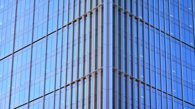 Şehir soyutu - ofis binasının pencereli duvarı. Şehirdeki modern iş binasının detaylı görüntüleri. Bir gökdelenin cam cephesine bakıyorum..
