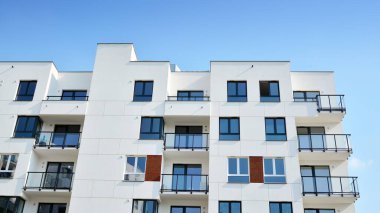Güneşli bir günde modern Avrupa konut mimarisi. Yeni çok katlı konut binasının dışı. Tüketiciler için konut satışı ve kiralama kavramı. Modern pencere ve balkonlar.