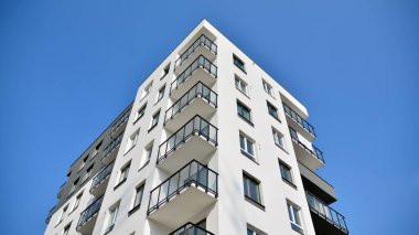 Güneşli bir günde modern Avrupa konut mimarisi. Yeni çok katlı konut binasının dışı. Tüketiciler için konut satışı ve kiralama kavramı. Modern pencere ve balkonlar.