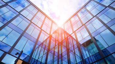  Bulutlu mavi gökyüzü arka planlı cam binalar. Camın çelik açık mavi arka planına geniş açılı bir bakış açısı. Ticari modern geleceğin şehri. Başarılı mimari iş kavramı.