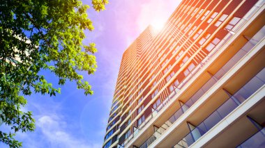 Çok katlı, modern bir apartmanın dış cephesi, pencereleri ve balkonları..