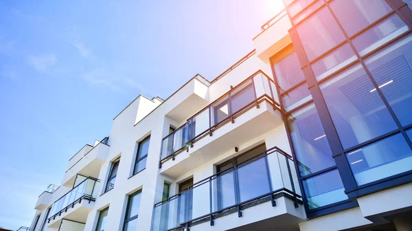 Modern apartment building. An innovative approach to residential architecture. Sunlight flare in the sky.