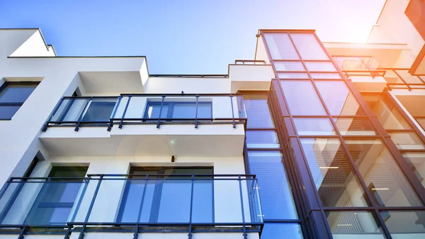 Modern apartment building. An innovative approach to residential architecture. Sunlight flare in the sky.