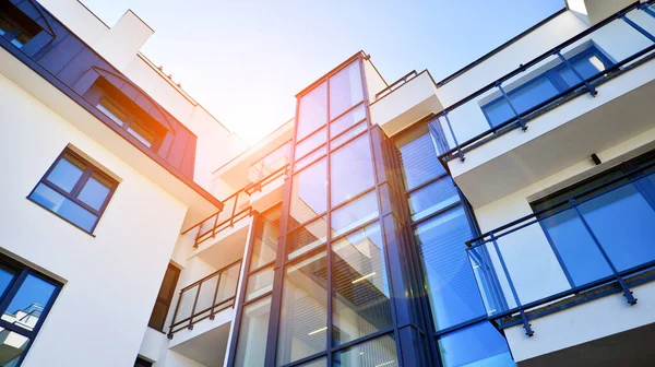 Modern apartment building. An innovative approach to residential architecture. Sunlight flare in the sky.