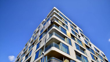 Modern luxury residential flat. Modern apartment building on a sunny day. Apartment building with a blue sky. Facade of a modern apartment building.