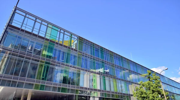 Modern glass facade against blue sky. Bottom view of a  building in the business district. Low angle view of the glass facade of an office building.