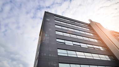 Glass and aluminum facade of a modern office building. View of futuristic architecture. Office building with cloud reflection on windows