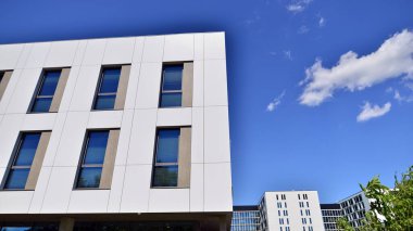 Office building with white aluminum composite panels. Facade wall made of glass and metal. Abstract modern business architecture.