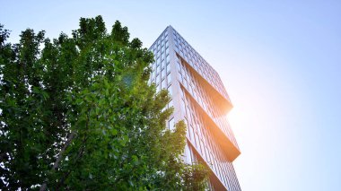 Mavi gökyüzü arka planında bir ofis binası. Şehrin merkezinde yüksek bir bina..