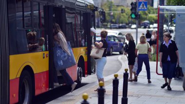 Warsaw, Poland. 10 August 2022. People get in and out of the bus at the stop.
