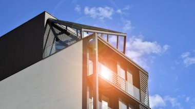 Çok katlı, modern bir apartmanın dış cephesi, pencereleri ve balkonları..