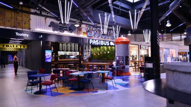 Szczecin, Poland. 29 August 2022. Foodport food court interiors and dining area of food court in Galaxy Shopping Centre.
