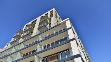 Modern luxury residential flat. Modern apartment building on a sunny day. Apartment building with a blue sky. Facade of a modern apartment building.
