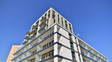 Modern luxury residential flat. Modern apartment building on a sunny day. Apartment building with a blue sky. Facade of a modern apartment building.