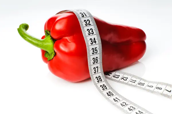 Red pepper in measure tape — Stock Photo, Image