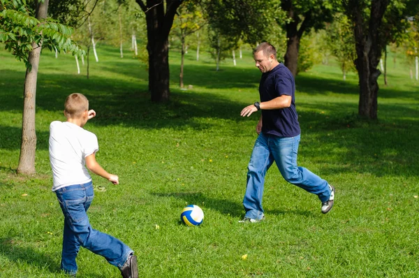 Giovane ragazzo che gioca a calcio con suo padre — Foto Stock