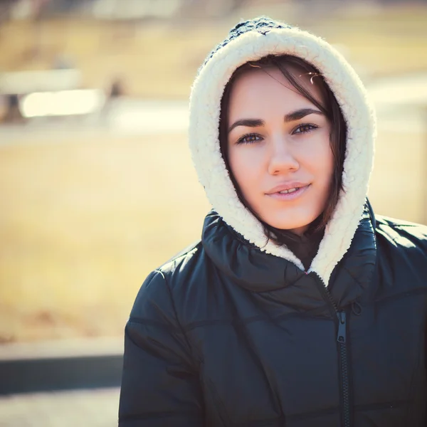 Young thoughtful woman in hood — Stock Photo, Image