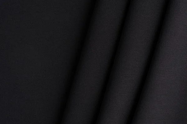 Черная ткань с прямыми складками — стоковое фото