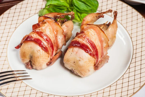 Two fried quails with bacon — Stock Photo, Image