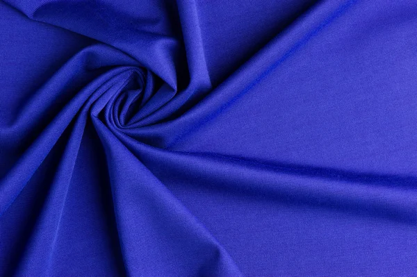 Spiral folds on blue cloth — Stock Photo, Image