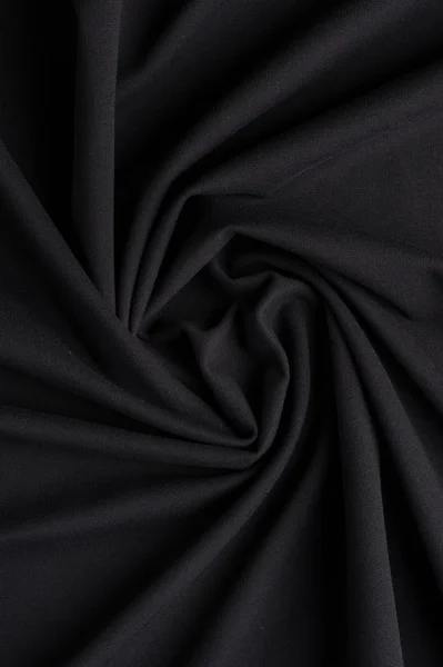 Σπείρα διπλώνει σε μαύρο ύφασμα — Φωτογραφία Αρχείου