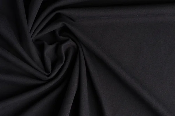 Spiral folds on black cloth — Stock Photo, Image