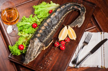 Roasted sturgeon with white wine clipart
