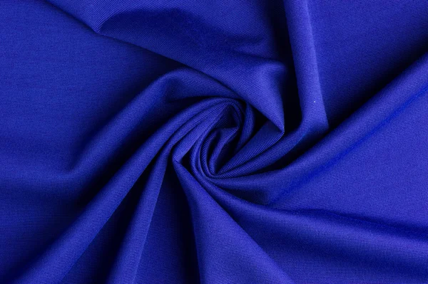Spiral folds on blue cloth — Stock Photo, Image