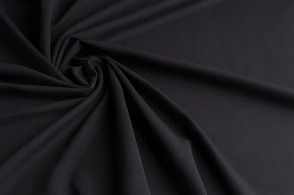 Spiral folds on black cloth — Stock Photo, Image