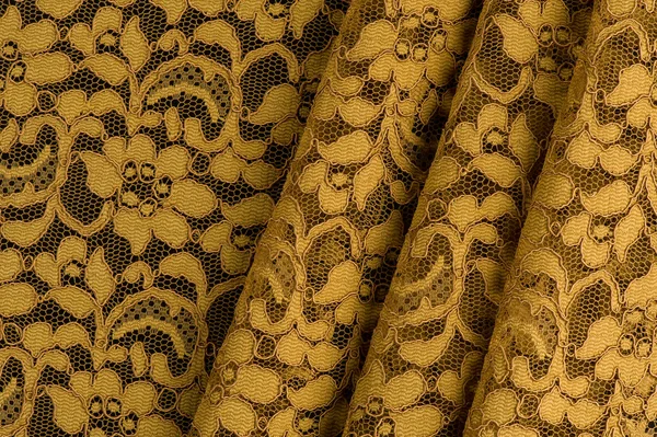 Yellow lace fabric with straight folds — Stock Photo, Image