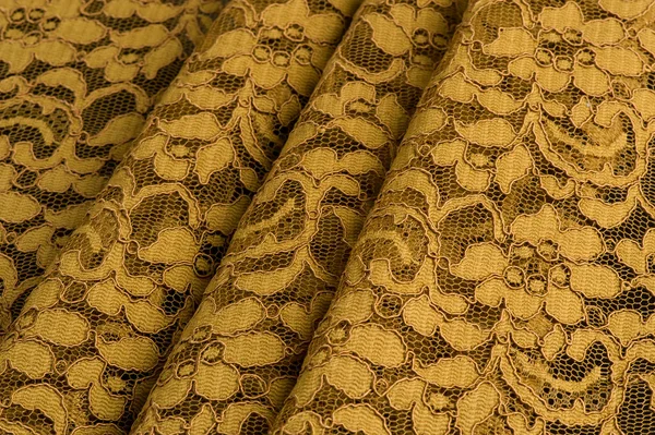 Yellow lace fabric with straight folds — Stock Photo, Image