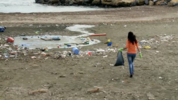 Mulher tentando limpar destruída e suja praia — Vídeo de Stock