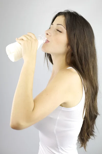 Gorgeous woman drinking from bottle of pure milk — Stock Photo, Image