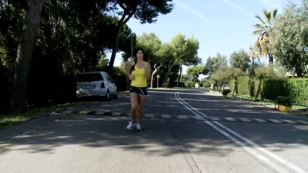 Frau joggt auf Straße — Stockvideo