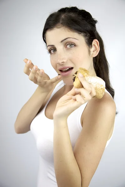 Beautiful woman eating chip chocolate holding snack — Stock Photo, Image