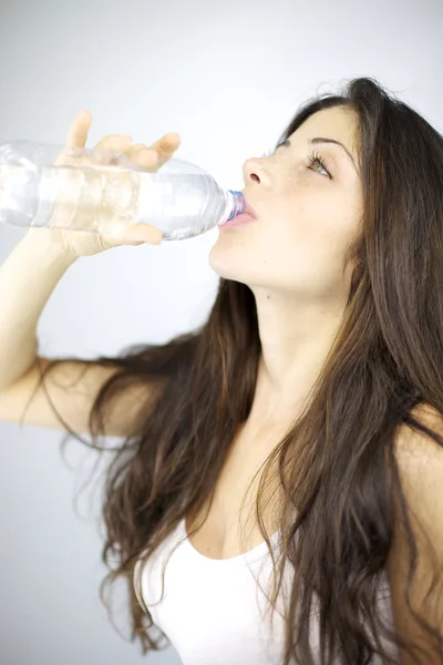 Young woman with amazing hair drinking water — Stock Photo, Image
