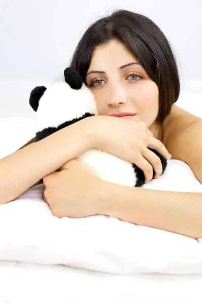 Portrait of young woman holding animal plush pensive — Stock Photo, Image