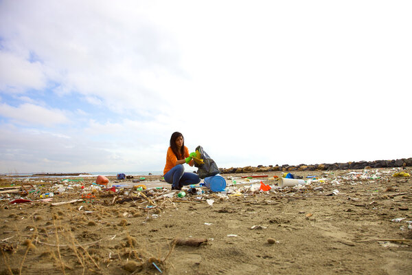 Young activist cleaning dirty beach