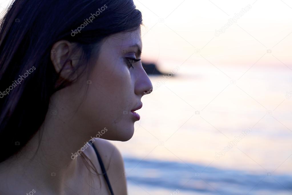 Sad woman crying during sunset