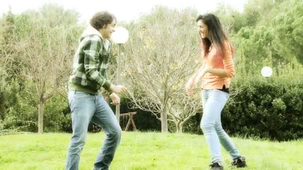 Boyfriend and girlfriend playing in park — Stock Video