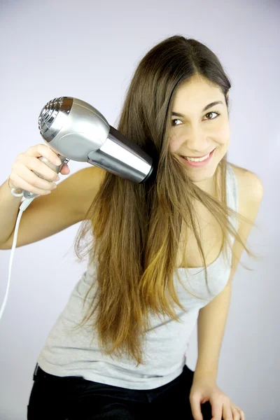 Feliz joven mujer secando el pelo largo — Foto de Stock