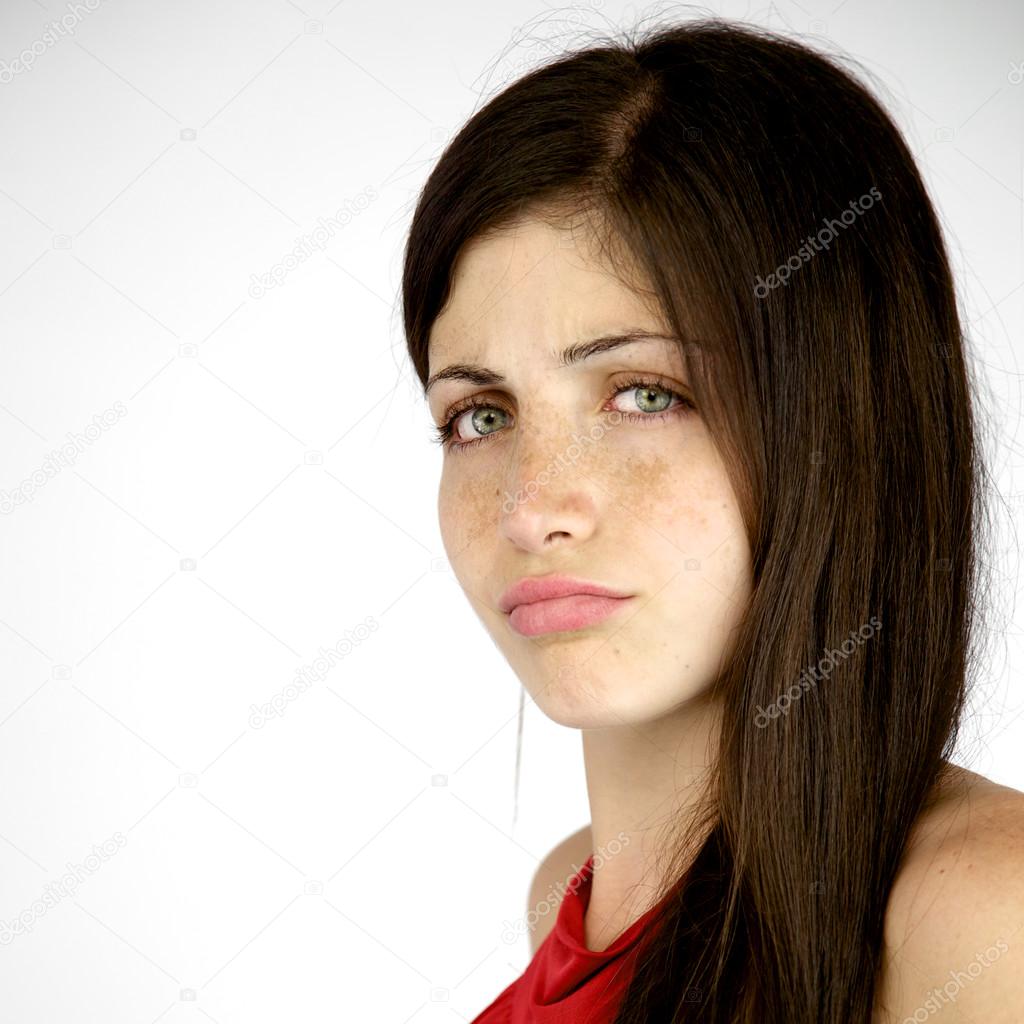 Unhappy shy woman with freckles