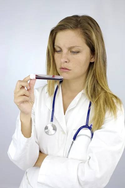 Doctor checking sample of blood — Stock Photo, Image
