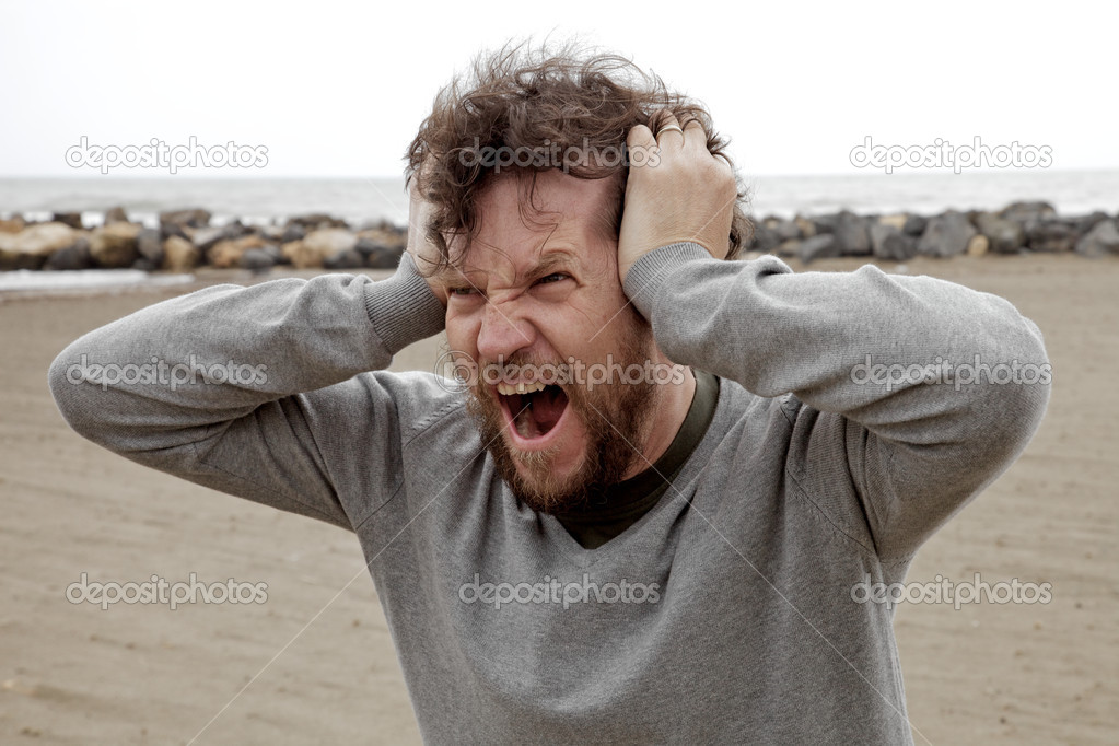 Desperate crazy man shouting on the beach