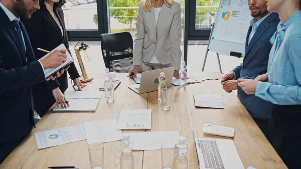 Cropped View Multiethnic Business People Standing Desk Laptops Documents Meeting — Stock Photo, Image