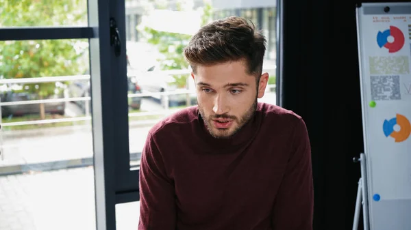 Young Businessman Turtleneck Blurred Flip Chart Graphs Office — Stock Photo, Image