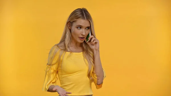 Mujer Rubia Hablando Por Teléfono Celular Haciendo Gestos Aislados Amarillo —  Fotos de Stock