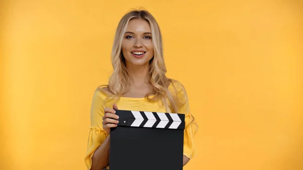 Happy Blonde Woman Holding Clapboard Looking Camera Isolated Yellow — Stock Photo, Image