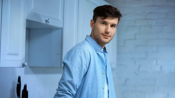 Positive Man Blue Shirt Looking Camera Kitchen — Stock Photo, Image